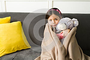 Adorable girl feeling cold at home