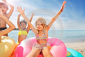 Adorable girl having fun with friends on the beach