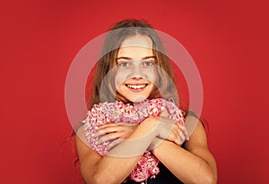 Adorable girl having fun. Romantic mood. Happy child hold heart red background. Holiday of love and care. Little girl