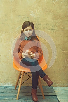 Adorable girl holding pink piggy bank