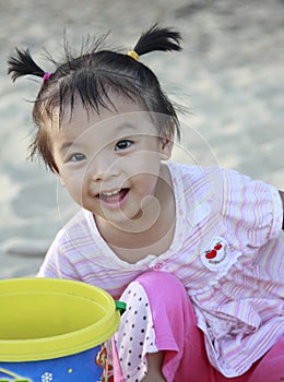 Adorable girl playing at sandbank