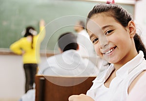 Adorable girl smiling in school