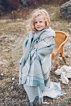 Adorable girl stay covered with blanket