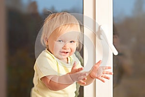 Adorable girl stay on the window sill