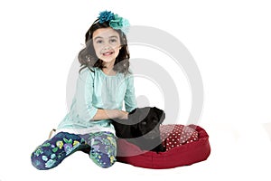 Adorable girl wearing blue outfit holding black puppy