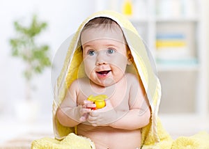 Adorable happy baby in towel