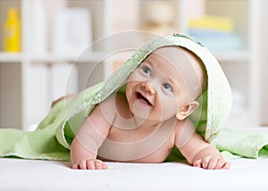 Adorable happy baby in towel