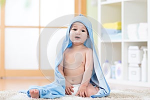 Adorable happy baby in towel