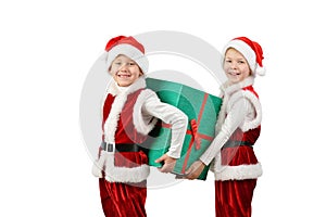 Adorable happy boys in santa clothes holding Christmas gift box. Isolated white background.