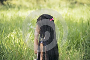 Adorable happy cute girl playful foam bubbles in green playground in summer outdoors. Funny Cheerful girl in the park happiness