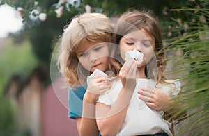 Adorable happy kids outdoors on summer day, little boy kissing a girl. Lovely little boy and girl, have fun and hugging
