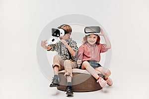 adorable happy kids using virtual reality headsets