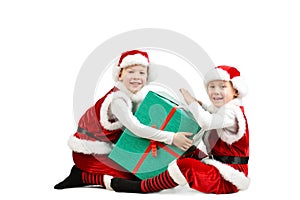 Adorable happy laughing boys in santa clothes holding Christmas gift box. Isolated white background.