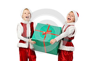 Adorable happy laughing boys in santa clothes holding Christmas gift box. Isolated white background.