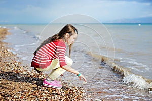 Adorable happy little girl on beach vacation