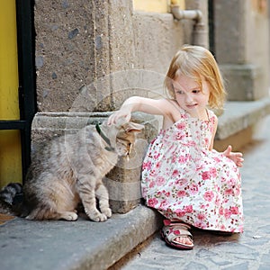 Adorable happy little girl and a cat