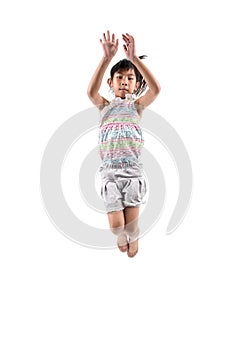 Adorable and happy little girl jumping in air.