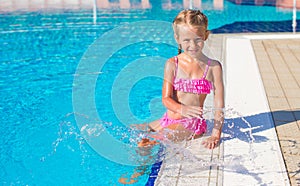 Adorable happy little girl in the swimming pool