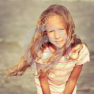 Adorable happy smiling girl on beach