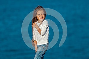 Adorable happy smiling little girl on beach