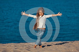 Adorable happy smiling little girl on beach