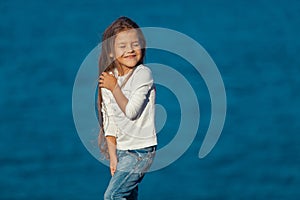Adorable happy smiling little girl on beach