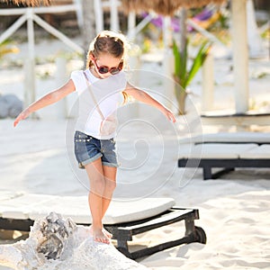 Adorable happy smiling little girl on beach