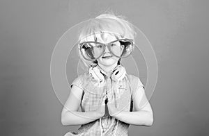 Adorable headset user with praying hands. Small child wearing adjustable white headset and pink hair wig. Little girl