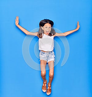 Adorable hispanic child girl wearing casual clothes smiling happy