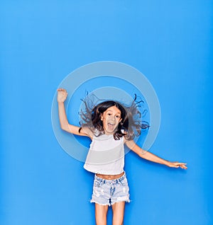 Adorable hispanic child girl wearing casual clothes smiling happy