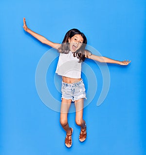 Adorable hispanic child girl wearing casual clothes smiling happy