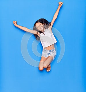 Adorable hispanic child girl wearing casual clothes smiling happy