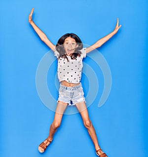 Adorable hispanic child girl wearing casual clothes smiling happy