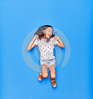 Adorable hispanic child girl wearing casual clothes smiling happy