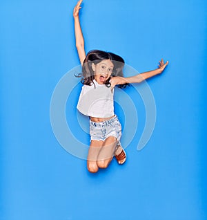 Adorable hispanic child girl wearing casual clothes smiling happy