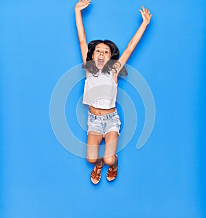 Adorable hispanic child girl wearing casual clothes smiling happy