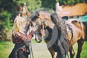 adorable horse cuddle with two women, friendship between animal and people