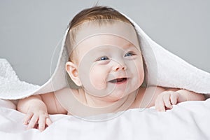 Adorable infant under blanket