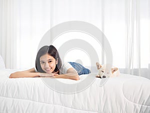 Adorable Japanese Shiba Inu dog sleep beside Asian teen girl lie down on bed with morning light in bedroom white background