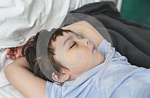 Adorable kid deep sleep in bed in the morning, Child  sleeping on bed. Little boy taking a peaceful nap, Children health care
