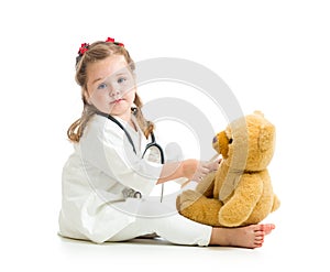 Adorable kid dressed as doctor playing with toy