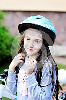 Adorable kid girl in blue helmet