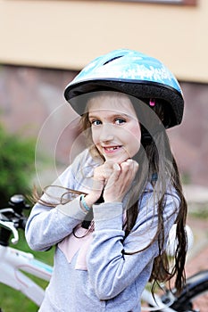 Adorable kid girl in blue helmet