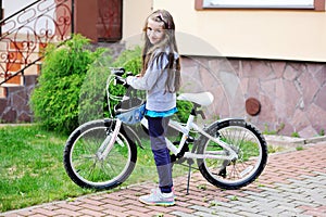 Adorable kid girl with her bike