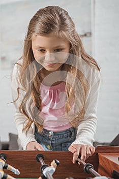 adorable kid playing table football