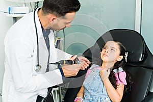 Adorable kid telling a pediatrician her symptoms photo