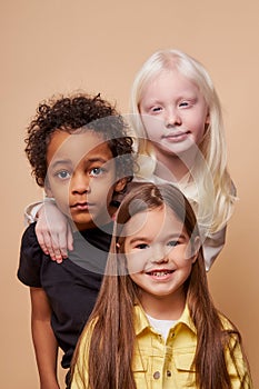 Adorable kids of diverse nationalities and skin colors stand together