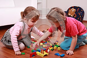 Adorable kids playing with blocks photo