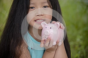 Adorable kids saving coins in piggy bank. Happy little investment saving money for happiness future. Girls smiling    with happy