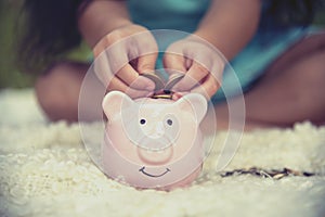 Adorable kids saving coins in piggy bank. Happy little investment saving money for happiness future. Girls smiling with happy